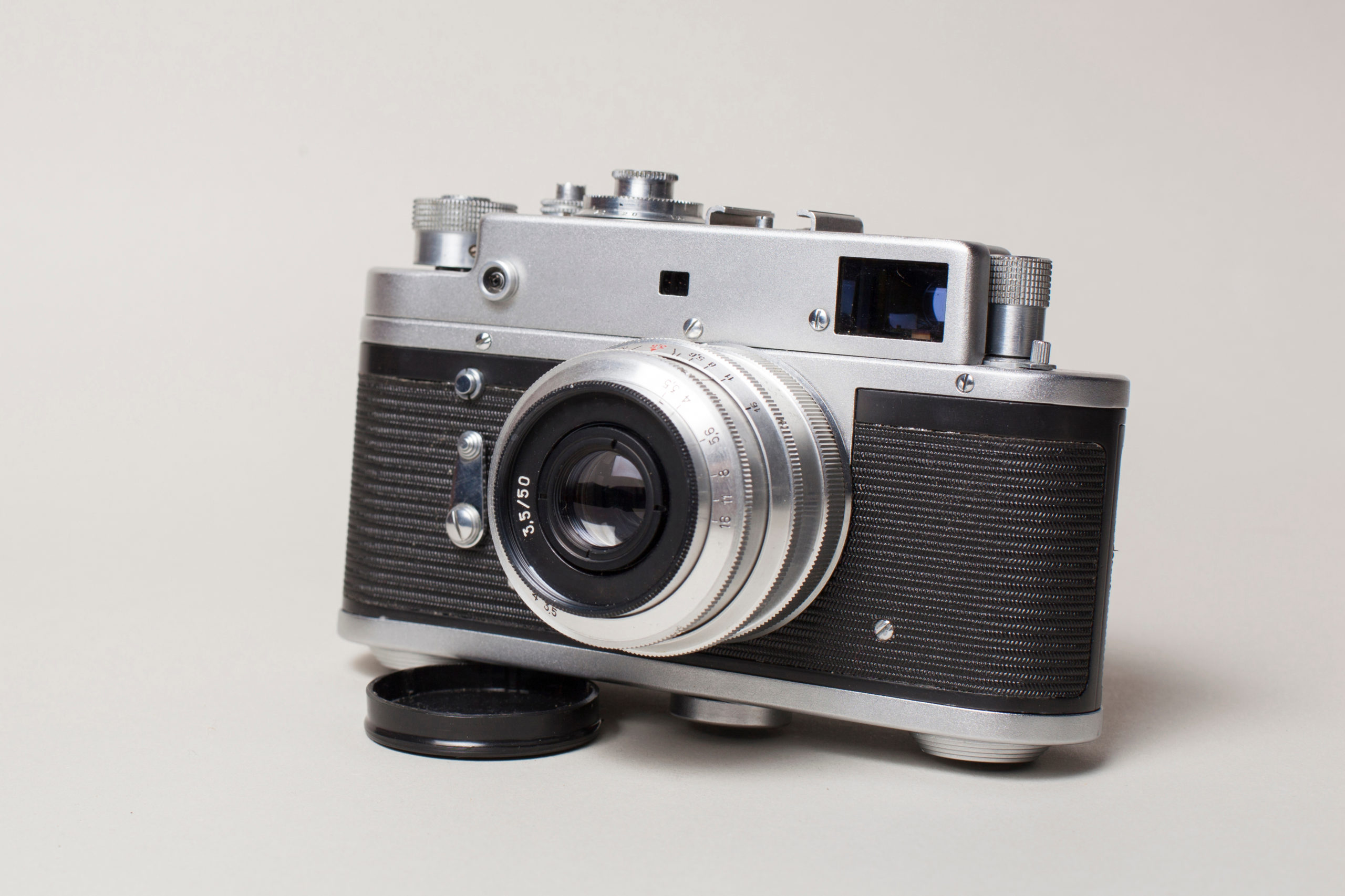 Vintage film camera on white table at Delray Camera & Studio